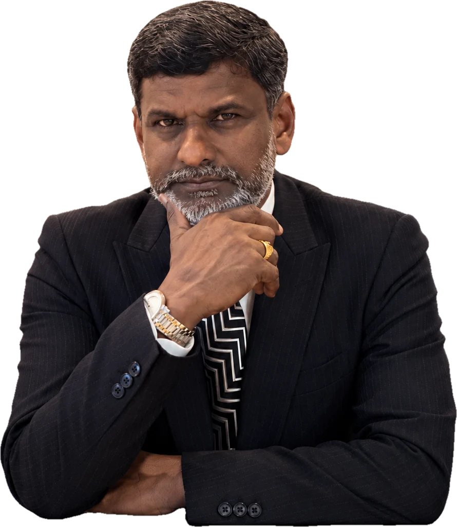 Prof. Sivarao Subramonian seated at a table, chin resting on his hand in thought